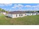 The spacious backyard has lush green grass, with a house with multiple windows and a brown roof at 15240 Sw 43Rd Ct, Ocala, FL 34473