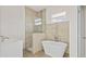 Bright bathroom features a freestanding tub, walk-in shower and stylish tile at 15240 Sw 43Rd Ct, Ocala, FL 34473