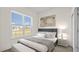 Comfortable bedroom featuring a large window, neutral decor, and ample natural light at 15240 Sw 43Rd Ct, Ocala, FL 34473