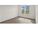 Bright bedroom with neutral walls, vinyl floors, baseboards and large window at 15240 Sw 43Rd Ct, Ocala, FL 34473