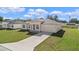 This home's exterior has a concrete driveway, lush green grass, and a two car garage at 15240 Sw 43Rd Ct, Ocala, FL 34473