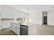 Modern kitchen features white cabinets, an island with stainless steel appliances, and an open floor plan at 15240 Sw 43Rd Ct, Ocala, FL 34473