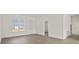 Bright, open-concept living room with wood-look flooring, large window and plenty of natural light at 15240 Sw 43Rd Ct, Ocala, FL 34473
