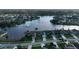 An aerial view shows serene neighborhood, with a lake featuring a fountain at 1646 Arash Cir, Port Orange, FL 32128