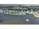 Aerial view of waterfront homes, complemented by a lake featuring a fountain in a scenic residential area at 1646 Arash Cir, Port Orange, FL 32128
