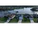 Aerial view of a neighborhood with well-maintained homes, lush lawns, and a scenic lake with a fountain at 1646 Arash Cir, Port Orange, FL 32128