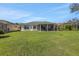Expansive backyard with a well-kept lawn and a covered lanai, perfect for outdoor living at 1646 Arash Cir, Port Orange, FL 32128