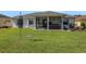 Spacious backyard with well-manicured lawn, complemented by a covered lanai and peaceful surroundings at 1646 Arash Cir, Port Orange, FL 32128