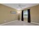 Neutral bedroom featuring tile flooring, a ceiling fan and an exterior view at 1646 Arash Cir, Port Orange, FL 32128