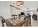 View of the dining room table with modern lighting and sliding door access to outdoor spaces and waterfront views at 1646 Arash Cir, Port Orange, FL 32128