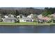 Waterfront homes boast screened lanais and lush lawns along the tranquil lake at 1646 Arash Cir, Port Orange, FL 32128