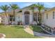 A lovely home's front entrance with a well-manicured lawn and desert plants at 1646 Arash Cir, Port Orange, FL 32128