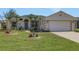 Charming single-Gathering home with a two car garage, meticulous landscaping, and lovely palm trees at 1646 Arash Cir, Port Orange, FL 32128