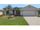 Beautiful single Gathering home with a two car garage and immaculately kept front lawn with palm trees at 1646 Arash Cir, Port Orange, FL 32128