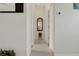 Bright hallway with neutral decor and tile floors, leading to various rooms in the home, creating a seamless flow at 1646 Arash Cir, Port Orange, FL 32128