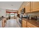 Open kitchen showcases stainless steel appliances, sleek countertops, and a sunny breakfast nook with picturesque views at 1646 Arash Cir, Port Orange, FL 32128