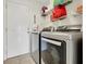 Laundry area with washer and dryer, wire shelving and an exterior door at 1646 Arash Cir, Port Orange, FL 32128
