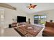 This home features an open living room with tile floors, large TV, and access to the lanai at 1646 Arash Cir, Port Orange, FL 32128