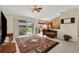 A large and open living room area with tile floors, a sliding glass door to the outside, and ceiling fan at 1646 Arash Cir, Port Orange, FL 32128