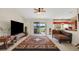 Spacious living room with vaulted ceilings, tile flooring, and sliding glass doors to the lanai at 1646 Arash Cir, Port Orange, FL 32128