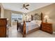 The main bedroom features an elegant bed frame, a ceiling fan, and a window with serene views at 1646 Arash Cir, Port Orange, FL 32128
