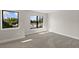 Bedroom featuring grey carpet, fresh paint and large windows at 1807 Simonton Ave, Orlando, FL 32806