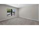 Bedroom featuring carpet, fresh paint and window with neighborhood view at 1807 Simonton Ave, Orlando, FL 32806