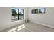 Bright bedroom with wood floors, two windows and fresh paint at 1807 Simonton Ave, Orlando, FL 32806