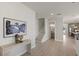Inviting entryway with stylish console table, artwork, stairs leading to upper level, and adjacent powder room at 1807 Simonton Ave, Orlando, FL 32806