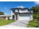 Contemporary two-story home featuring stone accents, a brick driveway, and a spacious two-car garage at 1807 Simonton Ave, Orlando, FL 32806