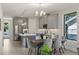 Open-concept kitchen and dining area featuring stainless steel appliances, gray cabinetry, and hardwood flooring at 1807 Simonton Ave, Orlando, FL 32806