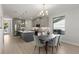 Open-concept kitchen and dining area featuring stainless steel appliances, gray cabinetry, and hardwood flooring at 1807 Simonton Ave, Orlando, FL 32806