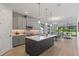 Open-concept kitchen with a large island, stainless steel appliances, and modern gray cabinetry at 1807 Simonton Ave, Orlando, FL 32806