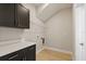 Laundry room with wood floors, white counter, and dark cabinets at 1807 Simonton Ave, Orlando, FL 32806