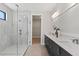 Sleek main bathroom with a glass-enclosed shower, double vanity, and neutral tile at 1807 Simonton Ave, Orlando, FL 32806