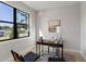 Well-lit home office with a large window, modern decor, and a stylish rug with two armchairs at 1807 Simonton Ave, Orlando, FL 32806