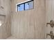 Modern shower with tan tile surround and square window allowing natural light at 1807 Simonton Ave, Orlando, FL 32806