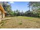 Large backyard with mature trees, open lawn space, and privacy at 1866 Matterhorn Dr, Orlando, FL 32818