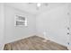 Minimalist bedroom with a ceiling fan, single window, and wood-look flooring at 1866 Matterhorn Dr, Orlando, FL 32818