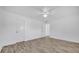 Spacious bedroom featuring wood-look flooring, ceiling fan, and ample closet space at 1866 Matterhorn Dr, Orlando, FL 32818