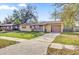 Charming single-story home with a driveway, garage and partially fenced front yard at 1866 Matterhorn Dr, Orlando, FL 32818