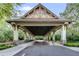 Grand entryway with porte-cochere welcomes you with stone accents and wood finishes at 25850 Crossings Bluff Ln, Sorrento, FL 32776