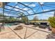 Spacious screened outdoor living space with pool, fire pit, and comfortable seating at 25850 Crossings Bluff Ln, Sorrento, FL 32776