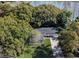 An aerial view of a home with lake access surrounded by mature trees and lawn at 2913 Carmia Dr, Orlando, FL 32806