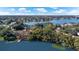 Aerial view showcasing a home with lake access and lush green trees and landscaping at 2913 Carmia Dr, Orlando, FL 32806