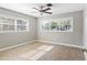 Bright bedroom with neutral walls, a ceiling fan, and large windows allowing ample natural light, creating a serene retreat at 2913 Carmia Dr, Orlando, FL 32806