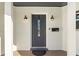 Close-up of elegant front door with decorative glass, stylish sconces, and clear address numbers at 2913 Carmia Dr, Orlando, FL 32806