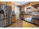 Spacious kitchen with stainless steel refrigerator, granite countertops, and plenty of cabinet storage at 2913 Carmia Dr, Orlando, FL 32806