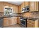 Well-equipped kitchen features light wood cabinets, stainless steel appliances, and tile backsplash at 2913 Carmia Dr, Orlando, FL 32806