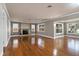 Bright living room boasts beautiful hardwood floors and a charming brick fireplace, offering a cozy and inviting atmosphere at 2913 Carmia Dr, Orlando, FL 32806